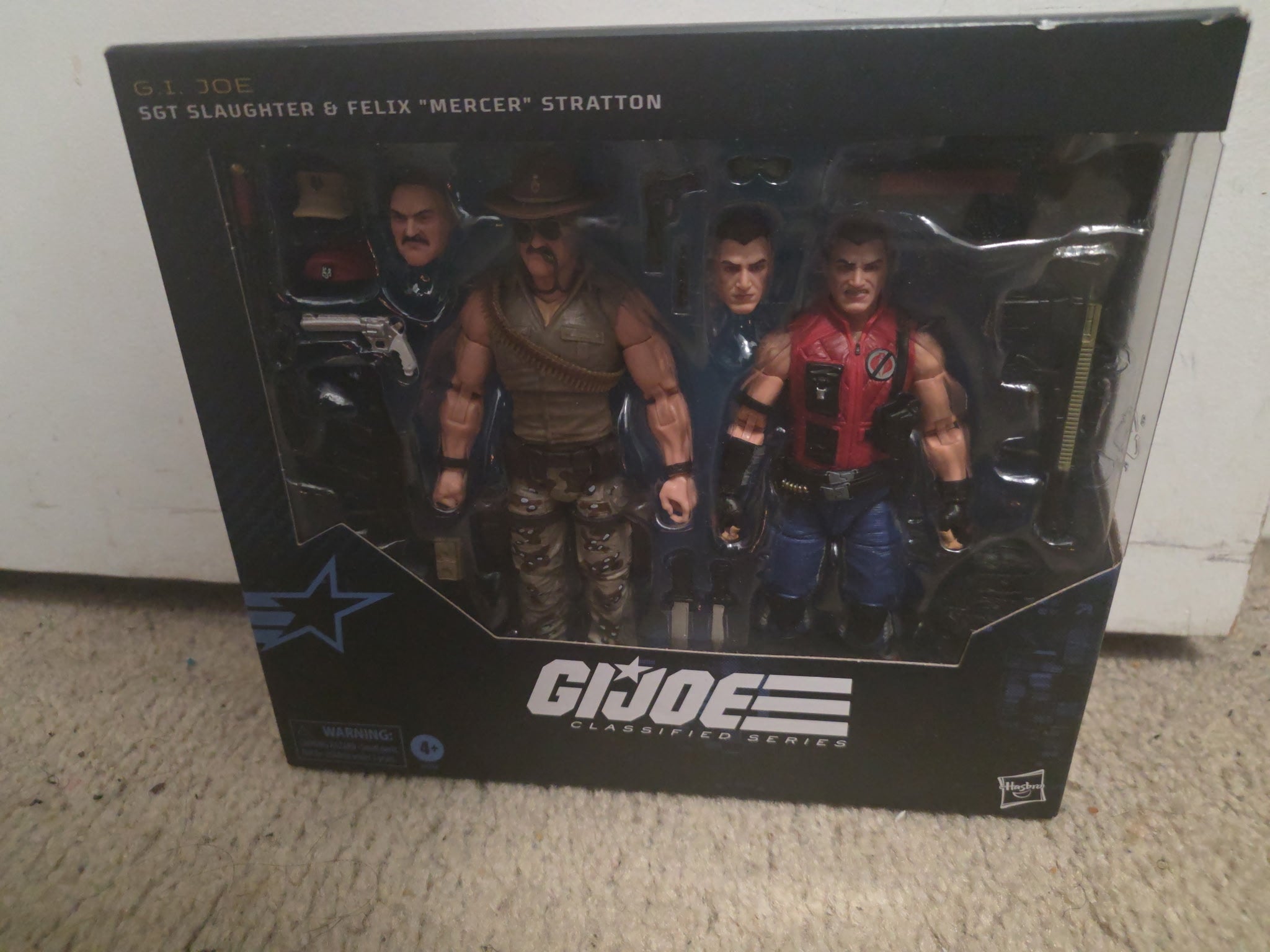 G.I. Joe action figure set in packaging on a carpeted floor.