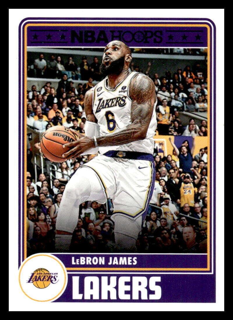 NBA Hoops trading card featuring LeBron James in Los Angeles Lakers uniform going for a layup with crowd in the background.