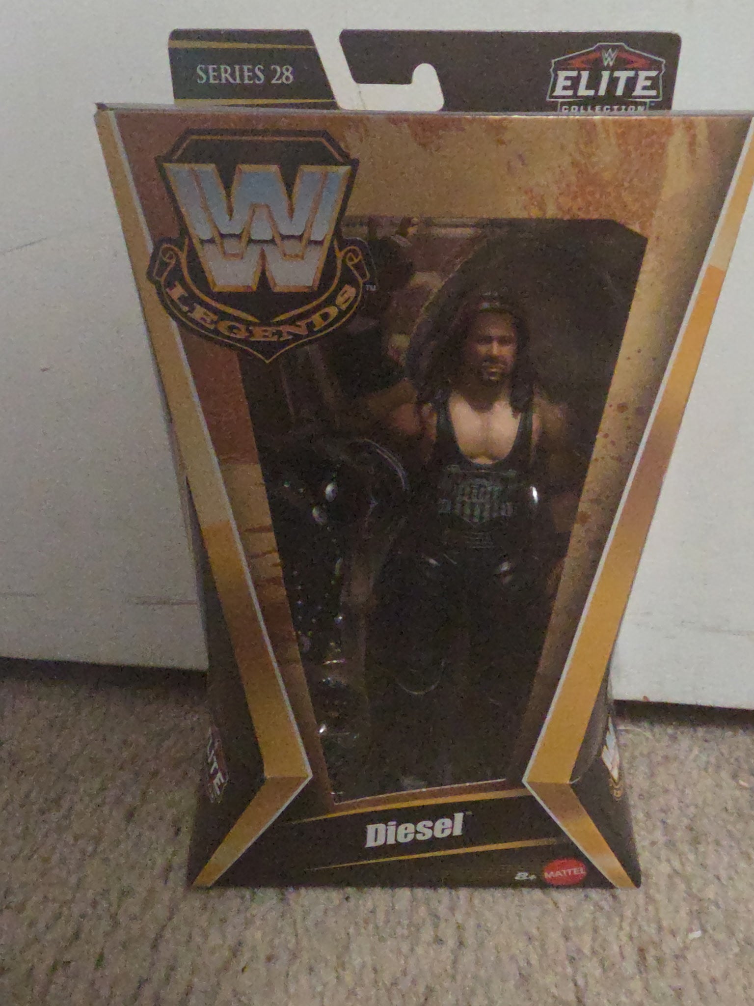 WWE Legends Diesel action figure in packaging on a carpeted floor